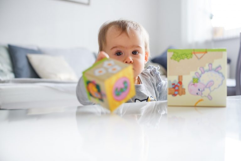 Sweet baby playing with educational toys. Baby development